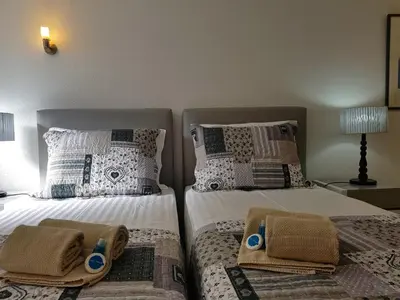 a bedroom with two beds with towels on them at Villa Violeta 51 - Clever Details in Vilamoura
