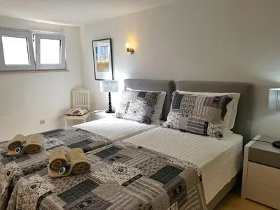 a bedroom with a bed with two slippers on it at Villa Violeta 51 - Clever Details in Vilamoura