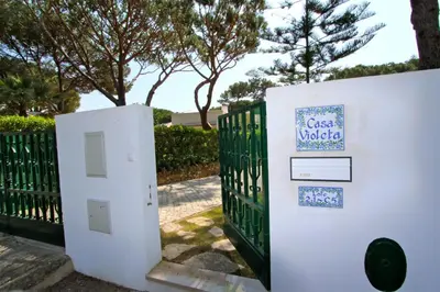 a gate with a sign on it next to a fence at Villa Violeta 51 - Clever Details in Vilamoura