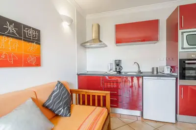 a glass table with a lantern and a cup on it at Apartamentos Solar do Sol in Albufeira