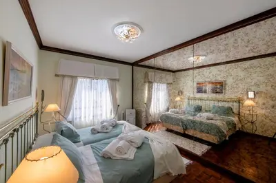 a bedroom with two beds and a couch in it at Blue Boat in Quarteira