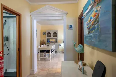 a living room with a table and a dining room at Blue Boat in Quarteira