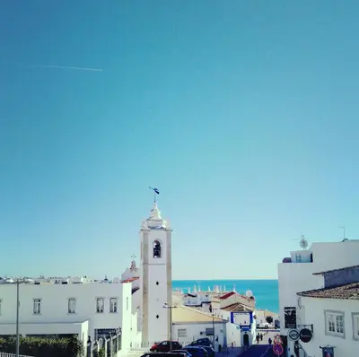 a clock tower with a bird on top of it at Little Wonder Apartment in Albufeira