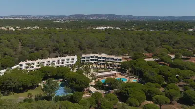 an aerial view of a resort with a pool and trees at Ancão Gardens in Quinta do Lago