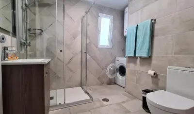 a bathroom with a shower and a washing machine at Albufeira, vista mar (63) in Albufeira