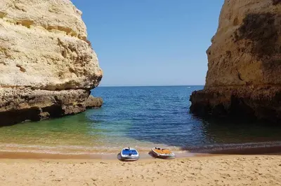 two boats sitting on a beach next to the ocean at Albufeira, vista mar (63) in Albufeira