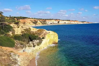 a view of a beach with the ocean and rocks at Albufeira, vista mar (63) in Albufeira