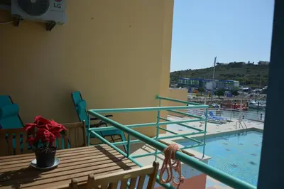 a balcony with a view of a swimming pool at Beautiful Apartment In Albufeira Marina in Albufeira
