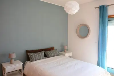 a bedroom with a bed with two night stands and a mirror at Beautiful Apartment In Albufeira Marina in Albufeira