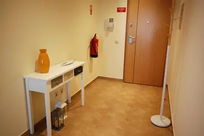 a room with a table with a vase on it at Apartamento Edificio Ibérico - Albufeira downtown in Albufeira