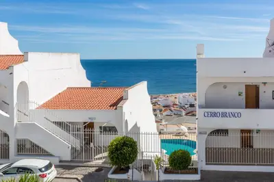 a view of the ocean from the balcony of a hotel at Apartamento Correia in Albufeira