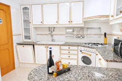 a bedroom with a bed with a television on the wall at Avenue Apartment in Quarteira