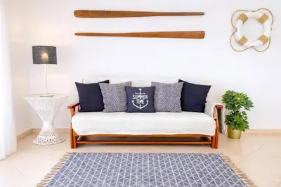 a living room with a couch and a table at Avenue Apartment in Quarteira