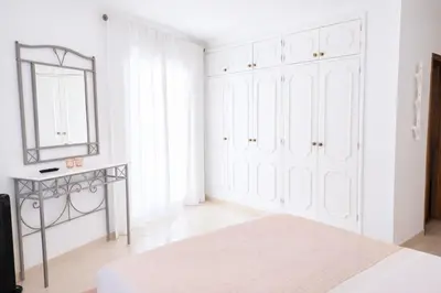 a kitchen with a counter with a refrigerator at Avenue Apartment in Quarteira