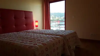 a bedroom with a bed with a large window at Albufeira Marina Villa 27 in Albufeira