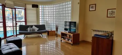 a living room with a chair and a television at Albufeira Marina Villa 27 in Albufeira