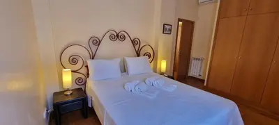 a bedroom with a large white bed with two towels at Albufeira Marina Villa 27 in Albufeira