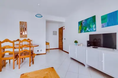 a kitchen with a sink and a washing machine at Apartamento T1 praia in Quarteira