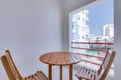 a living room with a couch and a window at Apartamento T1 praia in Quarteira