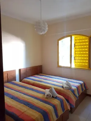 a bedroom with two beds and a window at GelbBlau Falésia in Albufeira