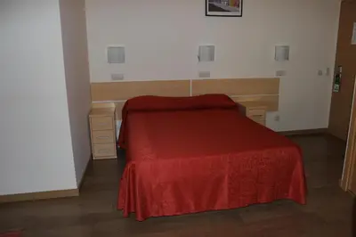 a bedroom with a bed with a red blanket at Dom Fernando II in Loulé
