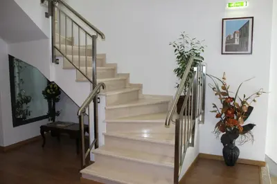 a staircase in a house with a vase of flowers at Dom Fernando II in Loulé