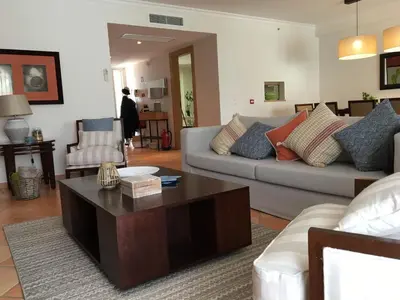 a living room with a couch and a coffee table at T3 Vila Sol Village in Quarteira