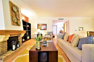 a living room with a couch and a fireplace at T3 Vila Sol Village in Quarteira