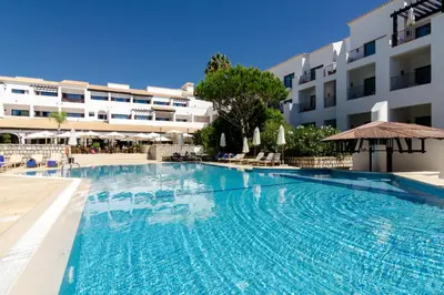a large swimming pool in front of a building at Algarve Luxury Experience - Situated within the Pinecliffs Resort in Albufeira