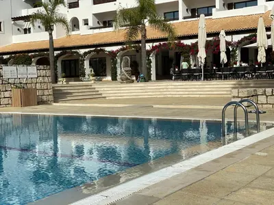 a swimming pool in front of a building at Algarve Luxury Experience - Situated within the Pinecliffs Resort in Albufeira