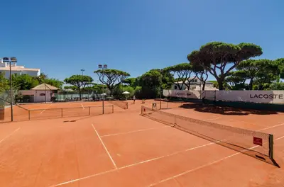 a tennis court with four tennis nets on it at Algarve Luxury Experience - Situated within the Pinecliffs Resort in Albufeira