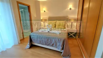 a bedroom with a bed and a glass wall at Moradia Townhouse Vila Rosal 2 in Albufeira