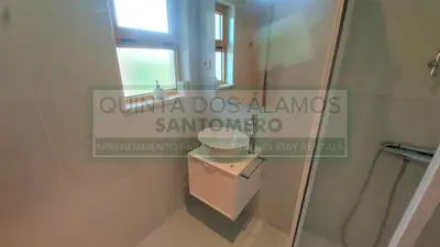 a bathroom with a toilet and a mirror at Moradia Townhouse Vila Rosal 2 in Albufeira
