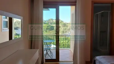 a bedroom with a view of a balcony at Moradia Townhouse Vila Rosal 2 in Albufeira