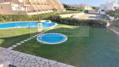 a guest house with a swimming pool in a complex at Moradia Townhouse Vila Rosal 2 in Albufeira