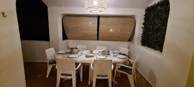 a dining room with a table and chairs and a window at Aldeia do Golf - Vila I4 in Vilamoura