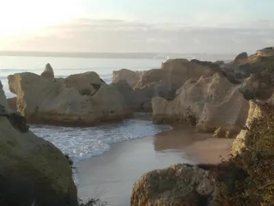 a beach with large rocks and the ocean at Wonder Villa in Albufeira