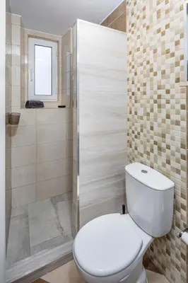 a bathroom with a toilet and a shower at Wonder Villa in Albufeira