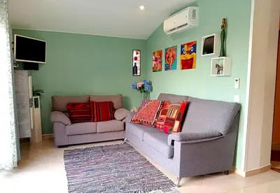 a living room with a couch and a tv at Wonder Villa in Albufeira