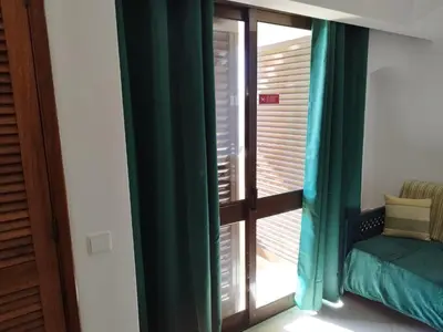 a room with a window with green curtains at Bellavista Tenis Clube A4 T1 - Albufeira INN in Albufeira