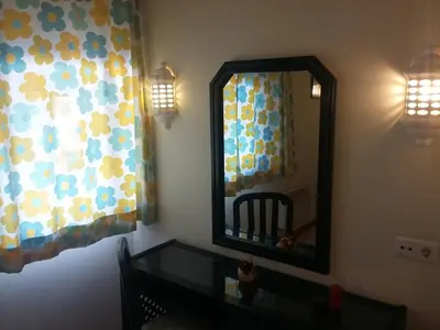 a mirror in a room with a table and a window at Bellavista Tenis Clube A4 T1 - Albufeira INN in Albufeira