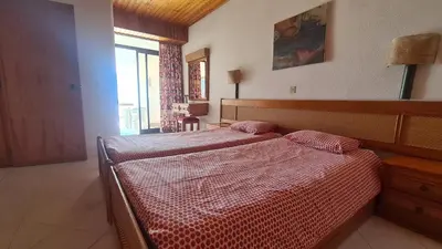 a bedroom with a bed and a large window at Albufeira Cerro Branco (23) in Albufeira