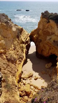 an opening in the rocks on a beach near the ocean at Albufeira Ocean view (62) in Albufeira