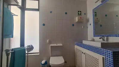 a bathroom with a toilet and a sink and a mirror at Albufeira Sea view (51) in Albufeira
