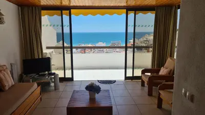 a living room with a view of the ocean at Albufeira Sea view (51) in Albufeira