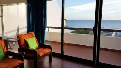 a room with a balcony with a view of the ocean at Albufeira sea view (52) in Albufeira