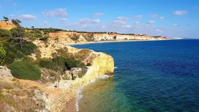 a beach next to the ocean on a cliff at Albufeira sea view (52) in Albufeira