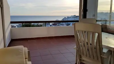 a balcony with a table and chairs and a view of the ocean at Albufeira sea view (52) in Albufeira