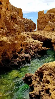 a body of water next to some rocks at Albufeira, Ocean terrace (22) in Albufeira