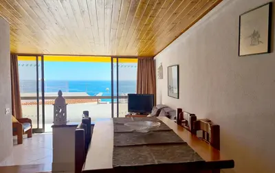 a living room with a table and a view of the ocean at Albufeira, Sea Balcony (11) in Albufeira